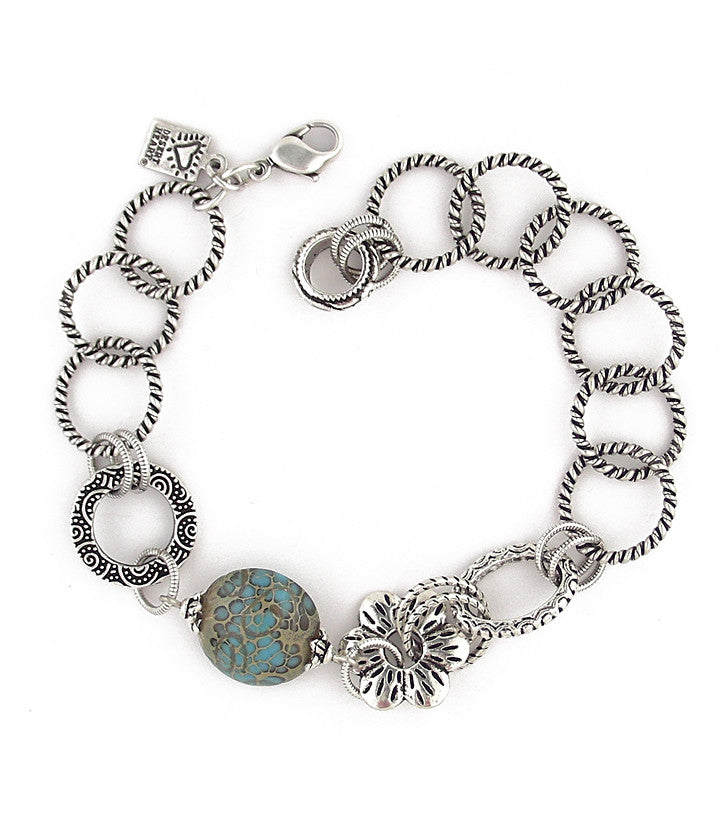 Cool bracelet with great glass, pewter and sterling plated and antiqued brass components. Extremely flexible sizing to 8"