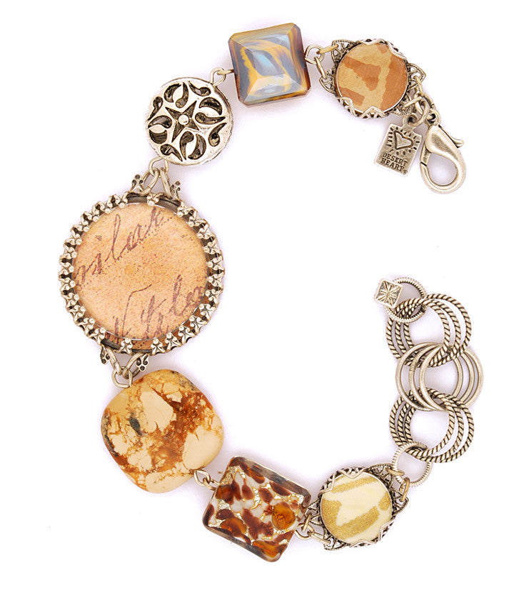 Beautiful, vintage inspired components made into a bracelet that makes a statement! Jasper, art paper, pewter, glass bubbles, buttons, pewter, glass, sterling plated and antiqued brass. 7.25”-8.5”