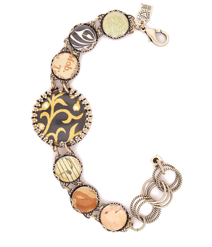 I love the mix of art papers on this fantastic ‘bubble bracelet’. Vintage inspired sterling plated and antiqued settings, pewter, glass bubbles. 6.75”-8”