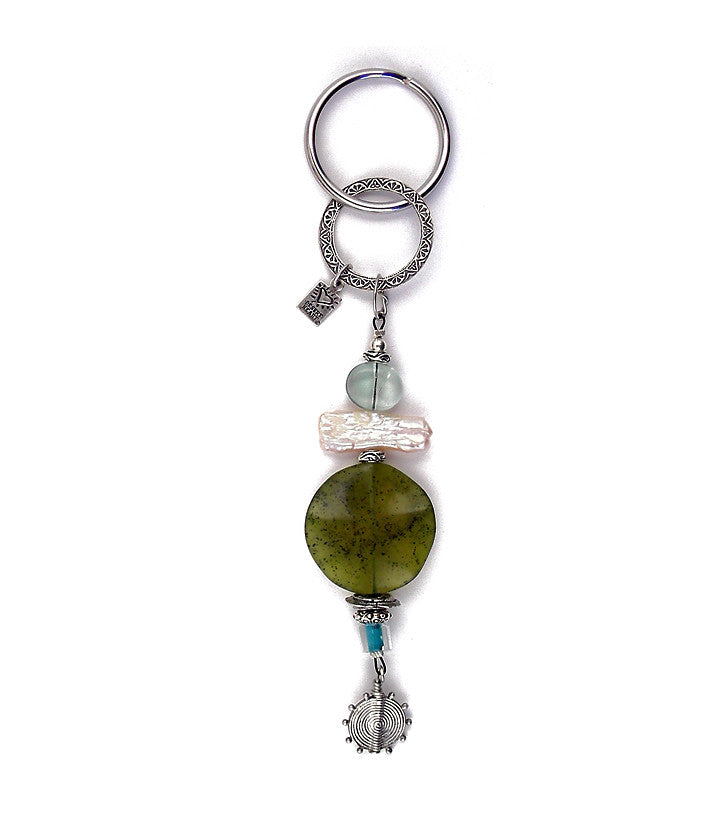 Another ode to summer and the beach. Olive jade and a biwa pearl are combined with flat out gorgeous blue/green fluorite, pewter and sterling plated and antiqued brass to make a little work of art just begging for that rental condo key. About 6” long