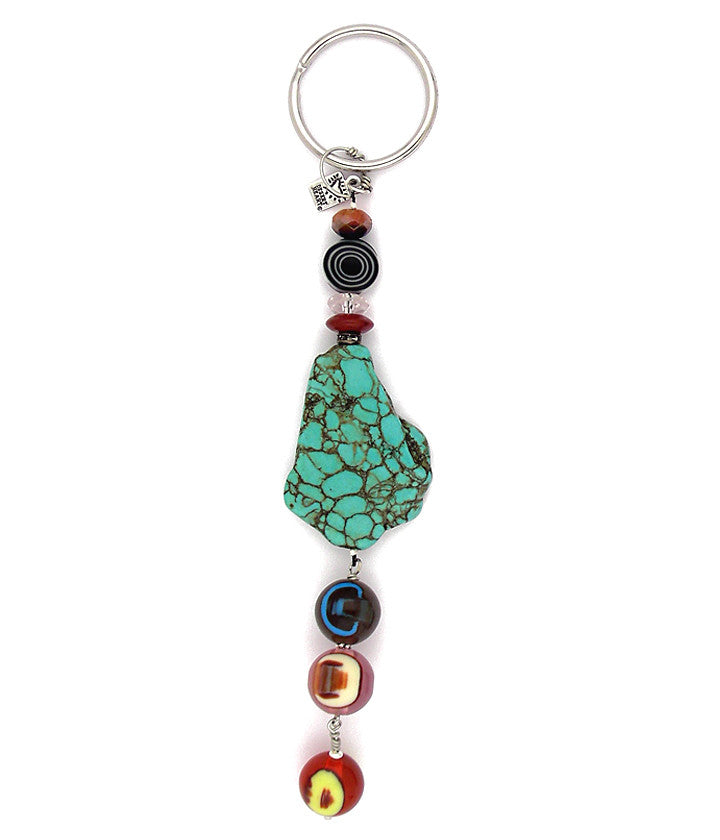 A big ol’ slab of dyed howlite is the centerpiece to this fun and whimsical design. We’ve combined glass and crystal and carnelian and acrylic. Hand wrapped and handmade rings are a part of the excellent craftsmanship. About 6” lo